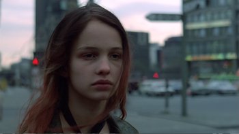 Movie still from “Christiane F.” (1981), directed by Uli Edel – A young woman is standing in the street; Close Up shot, Over the shoulder angle