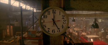 Movie still from “Christine” (1983), directed by John Carpenter – A clock on the side of a building; Extreme Close Up shot, Low angle