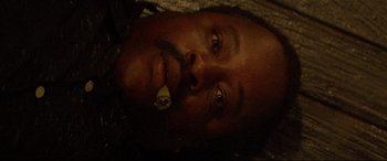 Movie still from “Christine” (1983), directed by John Carpenter – A person holding a banana in his mouth; Close Up shot, Overhead angle