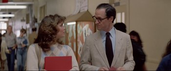 Movie still from “Christine” (1983), directed by John Carpenter – A man and a woman talking to each other; Medium shot, Over the shoulder angle