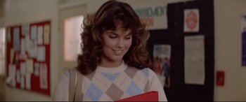 Movie still from “Christine” (1983), directed by John Carpenter – A woman with long hair holding a red bag; Close Up shot, Over the shoulder angle