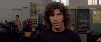 Movie still from “Christine” (1983), directed by John Carpenter – A person with long hair; Close Up shot, Low angle