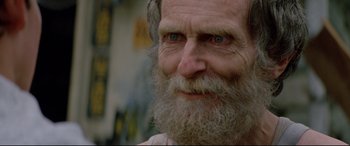 Movie still from “Christine” (1983), directed by John Carpenter – An old man with a long beard is smiling for the camera; Close Up shot, Low angle