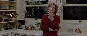 Movie still from “Christine” (1983), directed by John Carpenter – A woman standing in front of a kitchen sink; Medium shot, Low angle