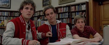 Movie still from “Christine” (1983), directed by John Carpenter – A group of young men sitting at a table in a library; Medium shot, Low angle
