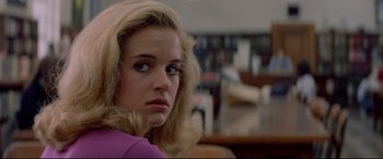 Movie still from “Christine” (1983), directed by John Carpenter – A person with blonde hair and blue eyes; Close Up shot, Over the shoulder angle