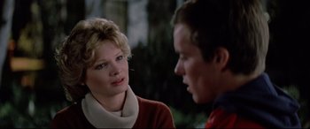 Movie still from “Christine” (1983), directed by John Carpenter – A woman and a man are talking to each other; Close Up shot, Over the shoulder angle