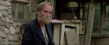 Movie still from “Christine” (1983), directed by John Carpenter – An old man with a beard and a jacket; Close Up shot, Low angle