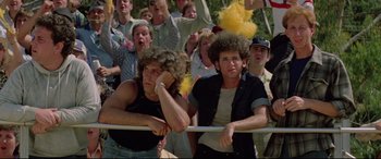 Movie still from “Christine” (1983), directed by John Carpenter – A group of people that are standing in a crowd; Medium shot, High angle