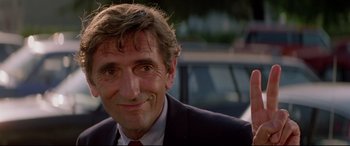 Movie still from “Christine” (1983), directed by John Carpenter – A person wearing a suit and tie; Close Up shot, Low angle