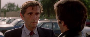 Movie still from “Christine” (1983), directed by John Carpenter – A man in a suit and tie talking to another man in a suit and tie; Close Up shot, Over the shoulder angle