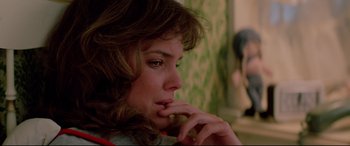 Movie still from “Christine” (1983), directed by John Carpenter – A person sitting with her hand on her chin; Close Up shot, Over the shoulder angle