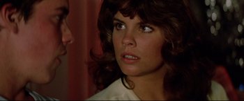 Movie still from “Christine” (1983), directed by John Carpenter – A person wearing a white shirt; Close Up shot, Over the shoulder angle