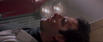 Movie still from “Christine” (1983), directed by John Carpenter – A man with blood all over his face and head; Close Up shot, Low angle