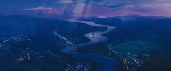 An aerial view of a river and a bridge at night
