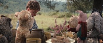 Movie still from “Christopher Robin” (2018), directed by Marc Forster – A boy and a teddy bear sitting at a dinner table; Medium shot, Over the shoulder angle