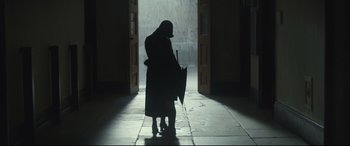 Movie still from “Christopher Robin” (2018), directed by Marc Forster – A person holding an umbrella in the rain; Wide shot, Low angle