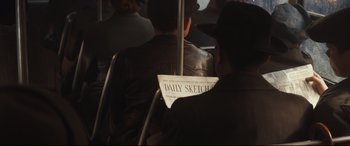 Movie still from “Christopher Robin” (2018), directed by Marc Forster – A man sitting on top of a bus holding a newspaper; Close Up shot, Over the shoulder angle