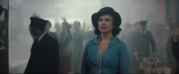 Movie still from “Christopher Robin” (2018), directed by Marc Forster – A group of people standing in a room; Medium shot, Over the shoulder angle