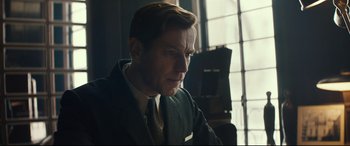 Movie still from “Christopher Robin” (2018), directed by Marc Forster – A person wearing a suit and tie; Close Up shot, Over the shoulder angle