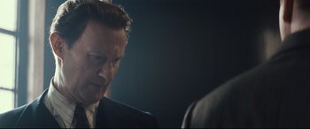 Movie still from “Christopher Robin” (2018), directed by Marc Forster – A person wearing a suit and tie; Close Up shot, Over the shoulder angle