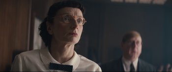 Movie still from “Christopher Robin” (2018), directed by Marc Forster – An older woman wearing glasses and a bow tie; Close Up shot, Low angle