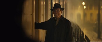 Movie still from “Christopher Robin” (2018), directed by Marc Forster – A man wearing a hat and a trench coat; Medium shot, Over the shoulder angle