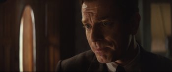 Movie still from “Christopher Robin” (2018), directed by Marc Forster – A person wearing a suit and tie; Close Up shot, Over the shoulder angle