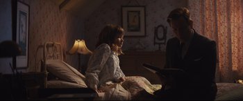 Movie still from “Christopher Robin” (2018), directed by Marc Forster – A little girl sitting on a bed next to a woman; Medium shot, Over the shoulder angle