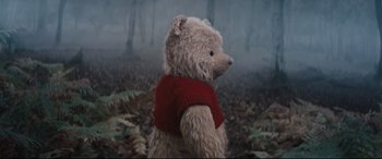 Movie still from “Christopher Robin” (2018), directed by Marc Forster – A teddy bear wearing a red sweater in a forest; Close Up shot, Low angle