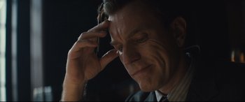 Movie still from “Christopher Robin” (2018), directed by Marc Forster – A person holding a cell phone to his head; Close Up shot, Over the shoulder angle