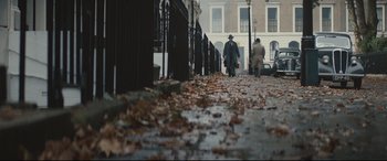 Movie still from “Christopher Robin” (2018), directed by Marc Forster – Two men walking down the sidewalk in the fall; Wide shot, High angle