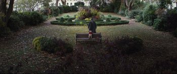 Movie still from “Christopher Robin” (2018), directed by Marc Forster – A man sitting on top of a wooden park bench; Wide shot, High angle