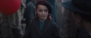 Movie still from “Christopher Robin” (2018), directed by Marc Forster – A young boy wearing a suit and a hat; Close Up shot, Over the shoulder angle