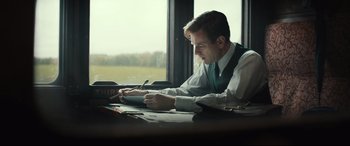 Movie still from “Christopher Robin” (2018), directed by Marc Forster – A man sitting at a table writing on a piece of paper; Medium shot, Over the shoulder angle