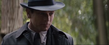 Movie still from “Christopher Robin” (2018), directed by Marc Forster – A person wearing a suit and hat; Close Up shot, Over the shoulder angle