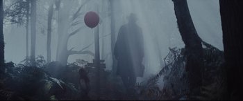 Movie still from “Christopher Robin” (2018), directed by Marc Forster – A man in a black coat walking through the woods; Wide shot, Low angle