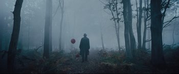 Movie still from “Christopher Robin” (2018), directed by Marc Forster – A man with a red balloon walking through the woods; Wide shot, Low angle