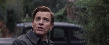 Movie still from “Christopher Robin” (2018), directed by Marc Forster – A person with a car in the background; Close Up shot, Over the shoulder angle