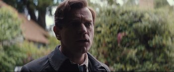 Movie still from “Christopher Robin” (2018), directed by Marc Forster – A person wearing a suit and tie; Close Up shot, Over the shoulder angle