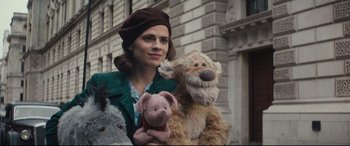 Movie still from “Christopher Robin” (2018), directed by Marc Forster – A woman holding two stuffed animals in her arms; Close Up shot, Low angle