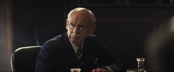 Movie still from “Christopher Robin” (2018), directed by Marc Forster – An older man wearing glasses and a suit; Close Up shot, Over the shoulder angle