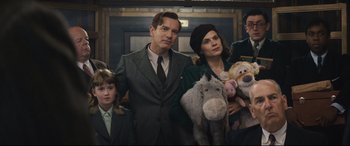 Movie still from “Christopher Robin” (2018), directed by Marc Forster – A group of people standing next to each other holding stuffed animals; Medium shot, Low angle
