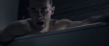 Movie still from “Chrysalis” (2007), directed by Julien Leclercq – A man with his mouth wide open in the shower; Close Up shot, High angle