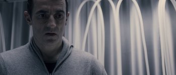 Movie still from “Chrysalis” (2007), directed by Julien Leclercq – A person wearing a hoodie; Close Up shot, Low angle