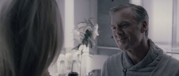 Movie still from “Chrysalis” (2007), directed by Julien Leclercq – A man and a woman are sitting at a table; Close Up shot, Over the shoulder angle