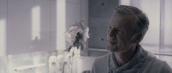 Movie still from “Chrysalis” (2007), directed by Julien Leclercq – A person sitting at a table; Close Up shot, Over the shoulder angle