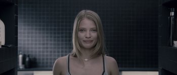 Movie still from “Chrysalis” (2007), directed by Julien Leclercq – A woman with long blonde hair wearing a tank top; Close Up shot, Low angle