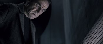 Movie still from “Chrysalis” (2007), directed by Julien Leclercq – A person looking down at his face; Close Up shot, Low angle