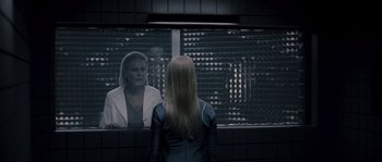 Movie still from “Chrysalis” (2007), directed by Julien Leclercq – A woman standing in front of a mirror looking at herself in the mirror; Medium shot, Over the shoulder angle